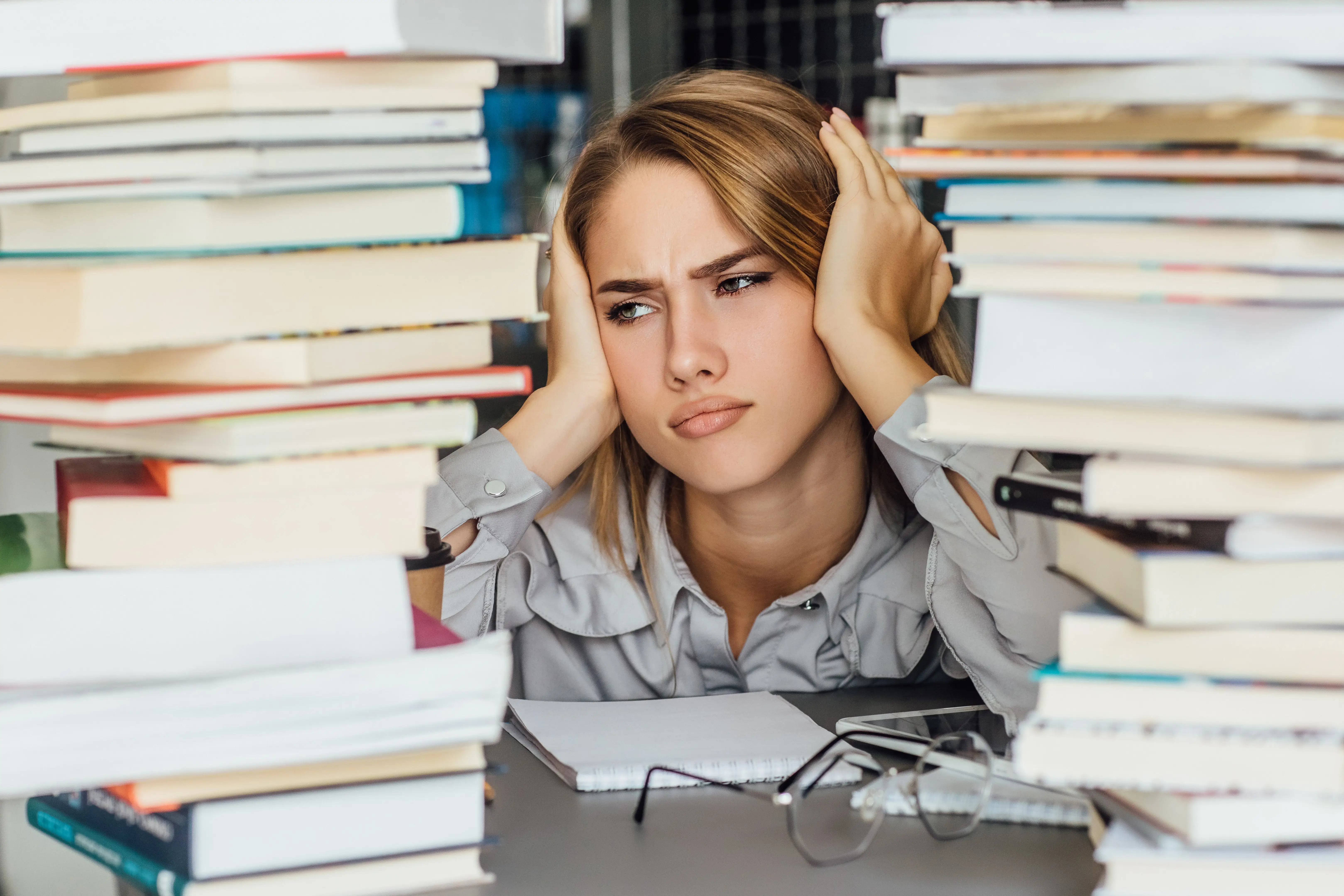 Frustrated professional woman looking tired and struggling with organization